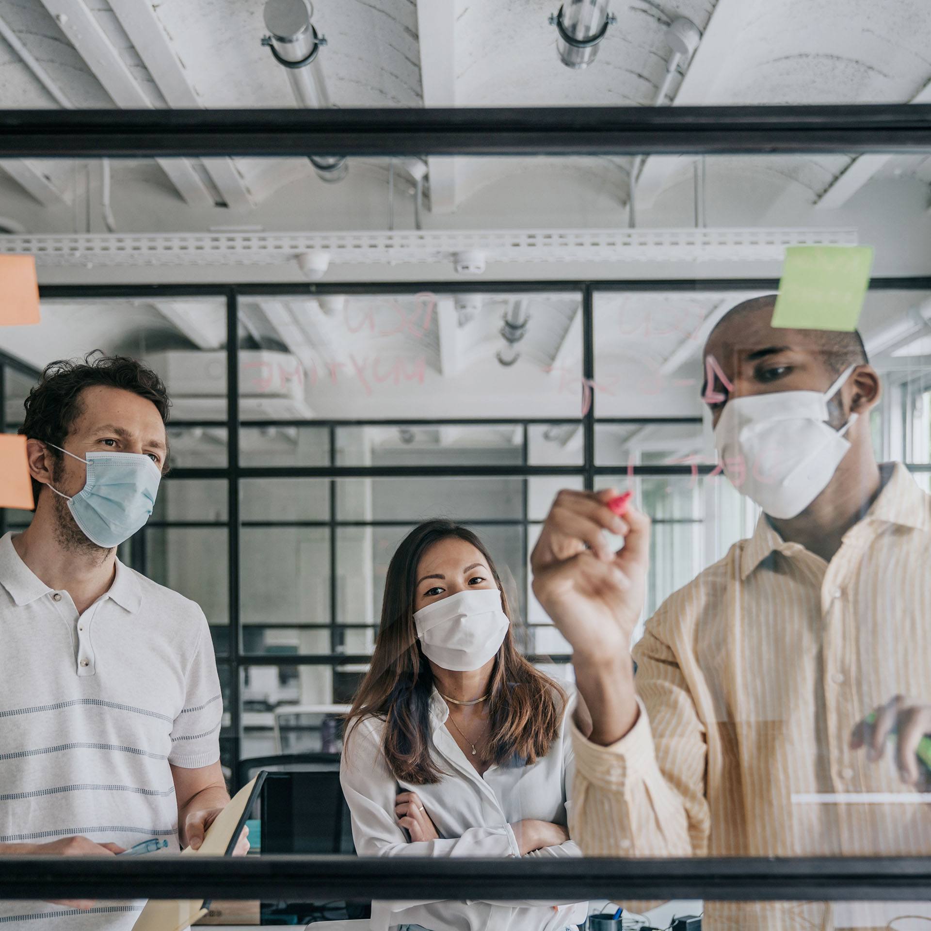 Businesspeople brainstorming work during the Covid-19 pandemic